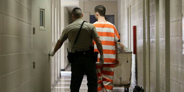 In this photo taken Thursday, Feb. 21, 2013, an inmate at the Madera County Jail is taken to one of the inmate housing units in Madera, Calif. County lockups, designed to hold prisoners for no more than a year are now being asked to incarcerate inmates serving the kind of lengthy sentences that used to send them to prisons. (AP Photo/Rich Pedroncelli)