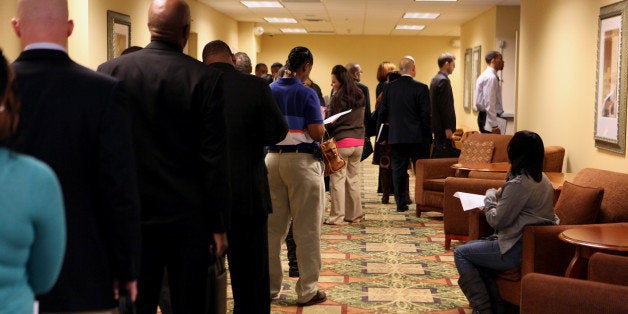 Job seekers wait in line to enter a job fair hosted by JobExpo.com in Dallas, Texas, U.S., on Wednesday, Jan. 29, 2014. The U.S. Department of Labor is scheduled to release initial jobless claims figures on Jan. 30. Photographer: Ben Torres/Bloomberg via Getty Images