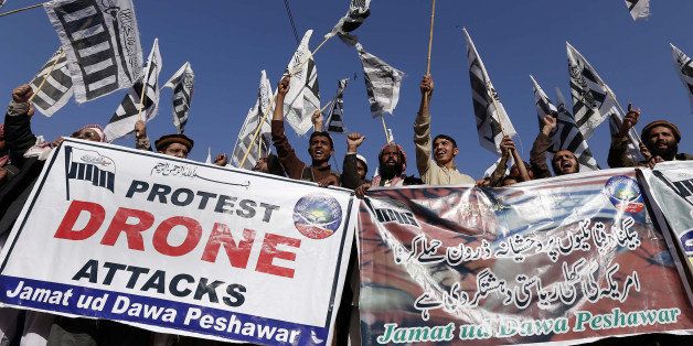 Supporters of Pakistan's banned Islamic group Jamaat-ud-Dawa (JuD) carry banners and shout anti-US slogans during a protest against US drone strikes in Pakistan's tribal region, in Peshawar on November 29, 2013. A US drone strike targeting a militant compound killed at least two suspected insurgents in a restive Pakistani tribal region near the Afghan border, officials said. AFP PHOTO / A MAJEED (Photo credit should read A Majeed/AFP/Getty Images)