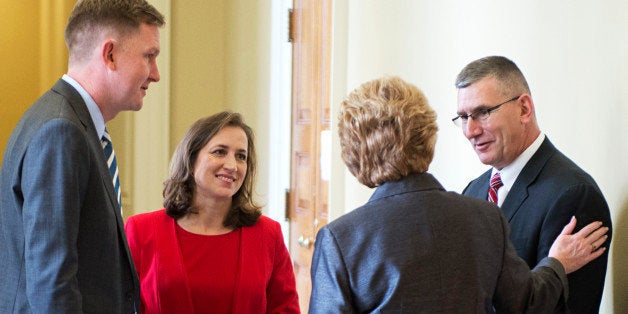 UNITED STATES - NOVEMBER 13: Sen. Debbie Stabenow, D-Mich., greets John Walsh, Lt. Gov. of Montana, and Natalie Tennant, left, Secretary of State of West Virginia, before the senate luncheons in the Capitol. Tennant and Walsh are running for senate seats in their states. Guy Cecil, executive director of the DSCC, appears at left. (Photo By Tom Williams/CQ Roll Call)