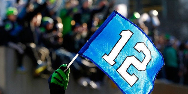 SEATTLE - FEBRUARY 05: Fans wave the 12th Man flag to celebrate Seattle Seahawks victory in Super Bowl XLVII during a parade on February 5, 2014 in Seattle, Washington. (Photo by Jonathan Ferrey/Getty Images)