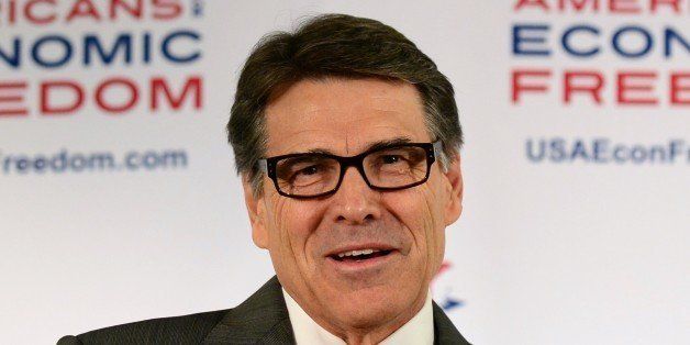 Texas Governor Rick Perry gestures while responding to questions during a press conference on the sidelines of the Republicans' State Party Convention in Anaheim, California, on October 4, 2013. More than 1,000 party activists and leaders are expected to attend the three-day convention. AFP PHOTO / Frederic J. BROWN (Photo credit should read FREDERIC J. BROWN/AFP/Getty Images)
