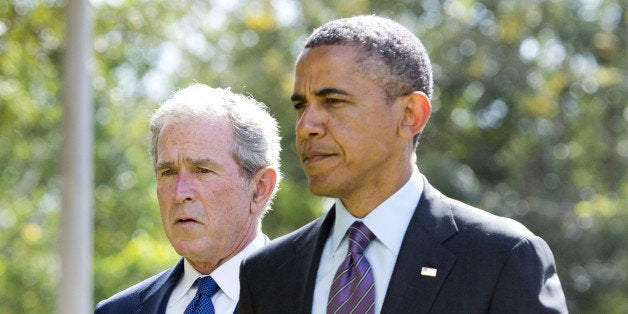 US President Barack Obama (R) and former US President George W. Bush arrive on July 2, 2013 for a wreath-laying ceremony for the victims of the 1998 US Embassy bombing at the Bombing Memorial in Dar Es Salaam. Bush is in Tanzania for a forum of regional First Ladies, hosted by his wife Laura, which will also be attended by First Lady Michelle Obama. AFP PHOTO / Saul LOEB (Photo credit should read SAUL LOEB/AFP/Getty Images)