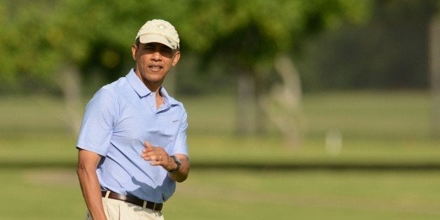 KANEOHE, HI - JANUARY 2: U.S. President Barack Obama lines up his putt on the second green while golfing with the Prime MInister of New Zealand John Key at Marine Corps Base Hawaii's Kaneohe Klipper Golf Course January 2, 2014 in Kaneohe, Hawaii. The Obama family is in Hawaii for the winter holidays. (Photo by Cory Lum-Pool/Getty Images)