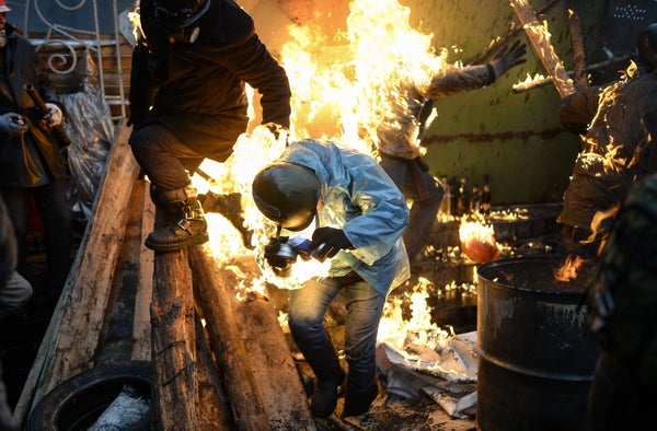 Protesters catch fire as they stand behind burning barricades during clashes with police on Feb. 20, 2014, in Kiev. Ukraine's