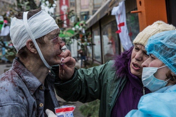 <br>A wounded anti-government protester is treated by medics near Independence Square on Feb. 20, 2014, in Kiev, Ukraine. Aft