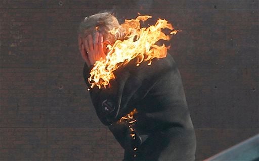 An anti-government protester is engulfed in flames during clashes with riot police outside Ukraine's parliament in Kiev, Ukra