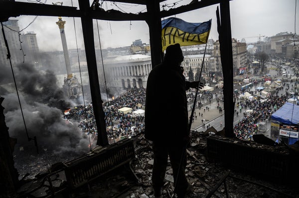 <br>A demonstrator stands on a balcony overlooking Independence square during the face-off against heavily armed police on Fe