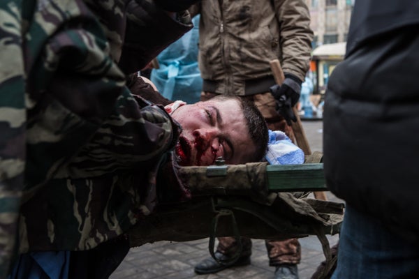 <br>A wounded anti-government protester is carried to a waiting ambulance on Feb. 20, 2014, in Kiev, Ukraine. After several w