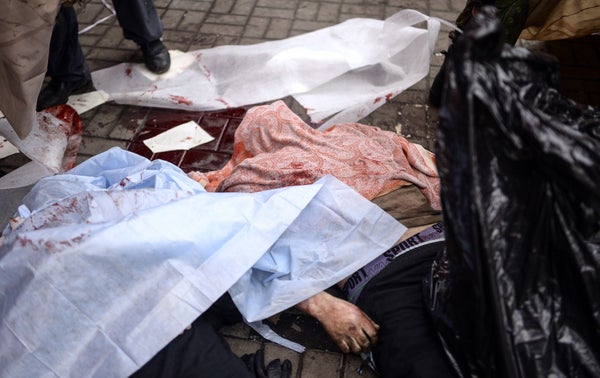 <br>Dead bodies lay covered on the ground during clashes with riot police in central Kiev on Feb. 20, 2014, in Kiev. At least