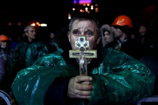 <br>An anti-government protester holds a crucifix as he prays at Independence Square in Kiev, Ukraine, on Feb. 20, 2014. Ukra