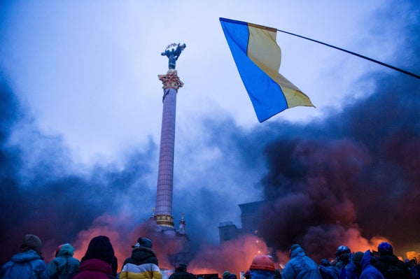 <br>Anti-government protesters stand behind a 'wall of smoke' during clashes with police in the center of Kiev on Feb. 20, 20