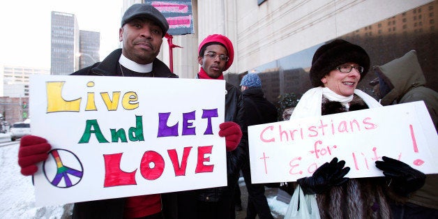 DETROIT, MI - MARCH 3: Pro-traditional marriage supporters protest next to gay marriage supporters in front of the U.S. Federal Courthouse March 3, 2014 in Detroit, Michigan. Plaintiffs Jayne Rowse and April DeBoer, a gay couple, have filed suit in Federal Court in an attempt to have Michigan's ban on gay marriage and gay adoption overturned. Current Michigan law defines marriage as the union of one man and one woman. (Photo by Bill Pugliano/Getty Images)