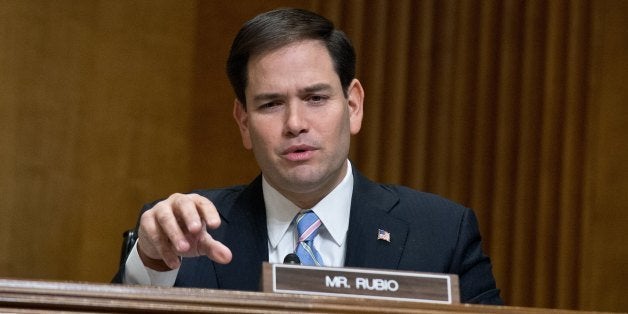 US Republican Senator from Florida Marco Rubio questions Senator Max Baucus as he testifies before the Senate Foreign Relatio