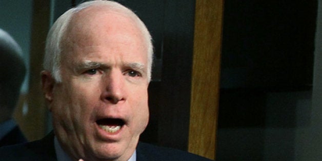 WASHINGTON, DC - FEBRUARY 14: U.S. Sen. John McCain (R-AZ) (R) gestures as he walks into a Senate Armed Services Committee hearing on Capitol Hill, February 14, 2012 in Washington, DC. The committee is hearing testimony from Defense Secretary Leon Panetta on the Defense Departments budget request for FY2013. (Photo by Mark Wilson/Getty Images)