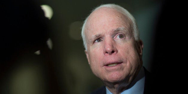 Senator John McCain, a Republican from Arizona, speaks to the media after leaving the Senate floor in Washington, D.C., U.S., on Wednesday, Feb. 12, 2014. The Senate cleared a measure suspending the U.S. debt limit for President Barack Obama's signature after Republicans dropped demands for policy conditions that in past years risked a potential default. Photographer: Andrew Harrer/Bloomberg via Getty Images
