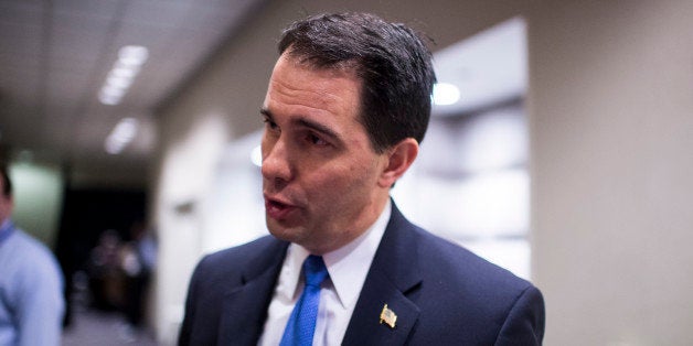 UNITED STATES - FEBRUARY 22: Wisconsin Governor Scott Walker speaks with a reporter in the hallway at the National Governors Association Winter Meeting at the JW Marriott in Washington on Saturday, Feb. 22, 2014. (Photo By Bill Clark/CQ Roll Call)