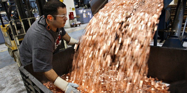 UNITED STATES - AUGUST 08: Mike Spinosa, a pit driver at the U.S. Mint, transfers one cent blanks before they are struck into pennies in Philadelphia, Pennsylvania on Wednesday, Aug. 8, 2007. The dollar fell to a record low against the euro after Federal Reserve policy makers cut their benchmark interest rate by a quarter-percentage point. (Photo by Stephen Hilger/Bloomberg via Getty Images)