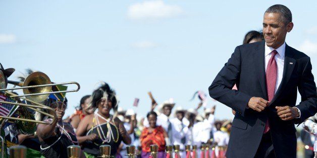 US President Barack Obama dances to music upon arrival on Air Force One at Julius Nyerere International Airport in Dar Es Salaam, Tanzania, on July 1, 2013. AFP PHOTO / Saul LOEB (Photo credit should read SAUL LOEB/AFP/Getty Images)