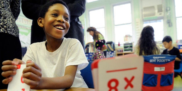 WASHINGTON, DC MARCH 30: Second grader, Renard Gray, 8, reacts to a problem as he is shown multiplication flash cards by classmate, Joselin Viveros, 7, as they learn Singapore Math techniques at Bruce-Monroe Elementary School at Park View on Wednesday 03/30/2011 in Washington, DC. (Photo by Matt McClain/The Washington Post via Getty Images)