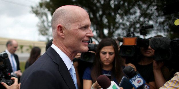 DAVIE, FL - MARCH 28: Florida Governor Rick Scott speaks to the media as he attends the ribbon cutting for the opening of a I-595 Express Project on March 28, 2014 in Davie, Florida. The Governor finds himself dogged by questions about recent resignations by one of his top fundraisers, Mike Fernandez, as well as Gonzalo Sanabria, a longtime Miami-Dade Expressway Authority board member, who is reported to have resigned Thursday from his post to protest the disparaging and disrespectful treatment of Mike Fernandez, the former co-finance chairman of Gov. Rick Scotts campaign.' (Photo by Joe Raedle/Getty Images)