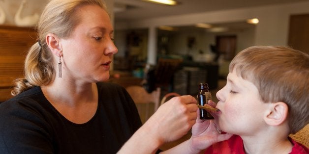 Nicole Gross moved her family from Illinois to Colorado to be able to get medicine derived from marijuana for son, Chase,7, who suffers from severe epilepsy that can hit him multiple times per day when not treated. Nicole is shown helping Chase with his medicine at their home in Colorado Springs. (Kevin Moloney/Chicago Tribune/MCT via Getty Images)