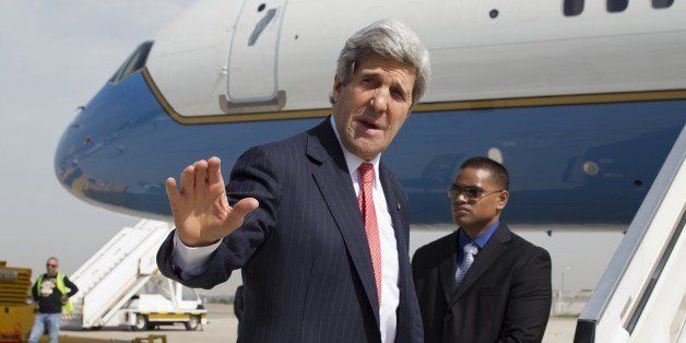 US Secretary of State John Kerry waves before boarding a plane while leaving Ben Gurion Airport after a meeting with Israeli Prime Minister on April 1, 2014. Kerry met Israel's Benjamin Netanyahu for the second time in 12 hours, as sources said a jailed US-Israeli spy could be key to saving troubled peace talks. AFP PHOTO / POOL / JACQUELYN MARTIN (Photo credit should read JACQUELYN MARTIN/AFP/Getty Images)