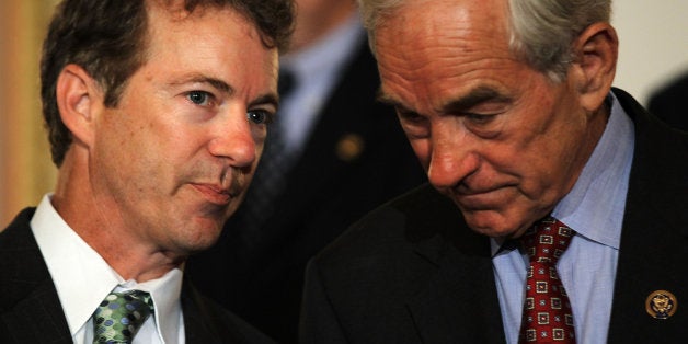 WASHINGTON - JUNE 22: U.S. Sen. Rand Paul (R-KY) (L) talks to his father Rep. Ron Paul (R-TX) (R) during a news conference June 22, 2011 on Capitol Hill in Washington, DC. A number of Republican congressional members joined The Cut, Cap, Balance Pledge Coalition at the news conference 'to oppose any debt ceiling increase unless a 'Cut, Cap and Balance' plan is passed.' (Photo by Alex Wong/Getty Images)