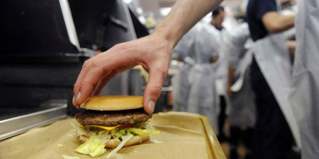 An employee prepares a hamburger at a US fast food Mac Donalds restaurant on December 1, 2011 in Ramonville-Saint-Agne, a Tou