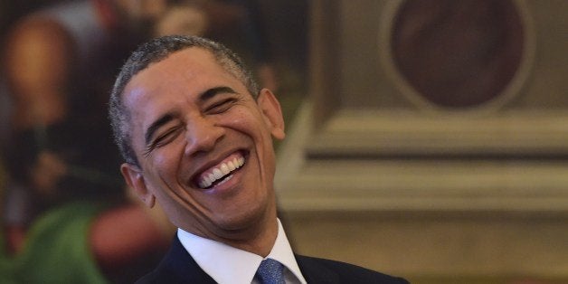 US President Barack Obama laughs during a private audience with Pope Francis on March 27, 2014 at the Vatican. The meeting at