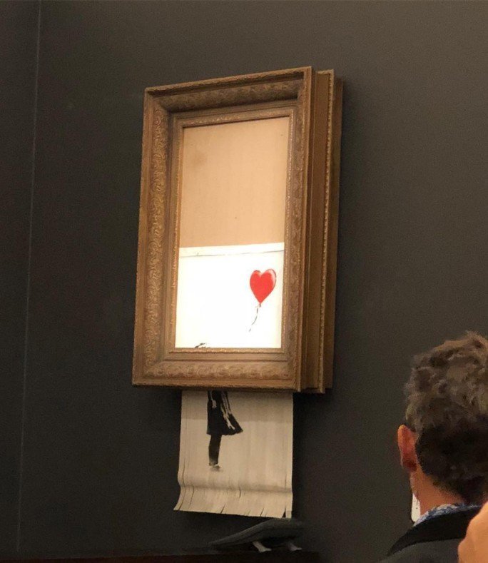 Banksy Painting Self Destructs Immediately After Being Sold For 1 4   5bb8c46f1f00004002256f15 