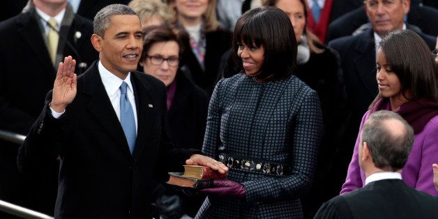 U.S. President Barack Obama, left, takes the oath of office from Supreme Court Chief Justice John Roberts, right, as first lady Michelle Obama holds the Lincoln Bible and the traveling bible of slain civil rights leader Martin Luther King Jr. during the ceremonial swearing-in at the presidential inauguration in Washington, D.C., U.S., on Monday, Jan. 21, 2013. As he enters his second term Obama has shed the aura of a hopeful consensus builder determined to break partisan gridlock and adopted a more confrontational stance with Republicans. Photographer: Andrew Harrer/Bloomberg via Getty Images 