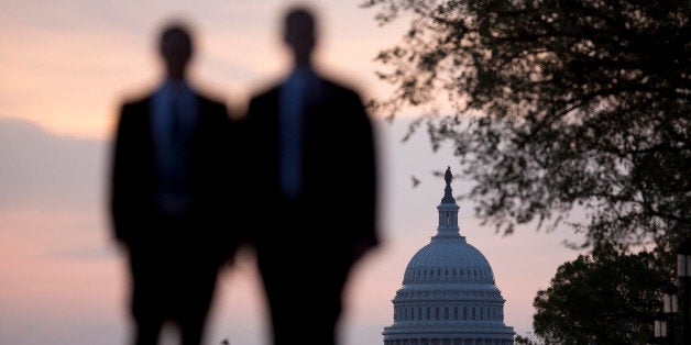 Men walk on the National Mall near the U.S. Capitol in Washington, D.C., U.S., on Monday, April 14, 2014. Republicans need to gain six additional seats to take control of the Senate, and Democratic incumbents are defending most of the hotly contested seats. The party's chances of retaining seats it now holds in Louisiana, Arkansas, Alaska, North Carolina and Michigan are all rated toss-ups by the Cook Political Report. Photographer: Andrew Harrer/Bloomberg via Getty Images