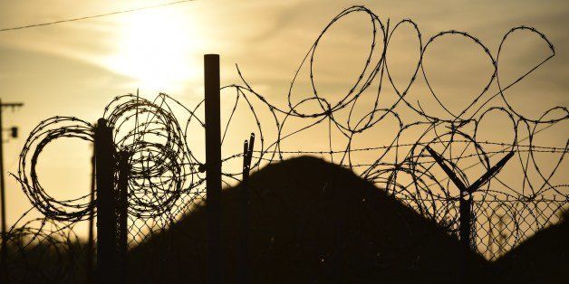 This photo made during an escorted visit and reviewed by the US military, shows the razor wire-topped fence at the abandoned 'Camp X-Ray' detention facility at the US Naval Station in Guantanamo Bay, Cuba, April 9, 2014. AFP PHOTO/MLADEN ANTONOV (Photo credit should read MLADEN ANTONOV/AFP/Getty Images)