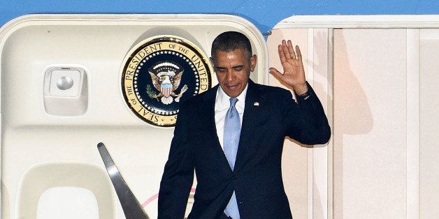 TOKYO, JAPAN - APRIL 23: U.S. President Barack Obama waves as he disembarks Air Force One upon arrival at Haneda Airport on April 23, 2014 in Tokyo, Japan. The U.S. President is on an Asian tour where he is due to visit Japan, South Korea, Malaysia and Philippines. (Photo by Jun Sato/Getty Images)
