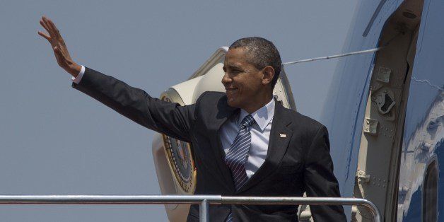 US President Barack Obama waves as he boards Air Force One at Haneda Airport in Tokyo on April 25, 2014, before departing for South Korea. Obama vowed on April 24 to defend Japan if China attacks over a tense territorial dispute, but also urged Beijing to step in to thwart North Korea's 'dangerous' nuclear march. AFP PHOTO / Jim WATSON (Photo credit should read JIM WATSON/AFP/Getty Images)