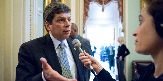 UNITED STATES - Dec 17: Sen. Mark Begich, D-AK., talks with reporters as he makes his way to the Senate luncheons in the U.S. Capitol on December 17, 2013. (Photo By Douglas Graham/CQ Roll Call)