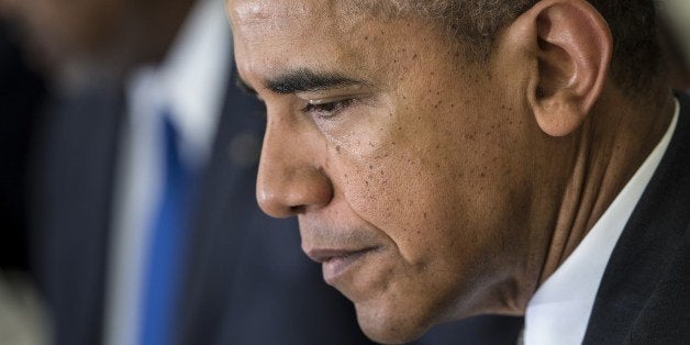 US President Barack Obama pauses while making a statement to the press with Djibouti President Ismail Omar Guelleh before a meeting in the Oval Office of the White House May 5, 2014 in Washington, DC. AFP PHOTO/Brendan SMIALOWSKI (Photo credit should read BRENDAN SMIALOWSKI/AFP/Getty Images)