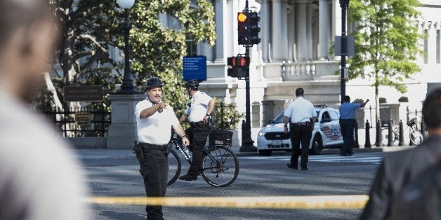 Members of the Secret Service Uniformed Division and DC Metro Police evacuate the area around Pennsylvania Avenue near the White House May 6, 2014 in Washington, DC. The area was locked down after the car was able to pass one of the road blocks protecting the White House campus. The two-block stretch of Pennsylvania Avenue in front of the White House was closed to automobile traffic by US President Bill Clinton in 1995 as a security measure. AFP PHOTO Brendan SMIALOWSKI (Photo credit should read BRENDAN SMIALOWSKI/AFP/Getty Images)