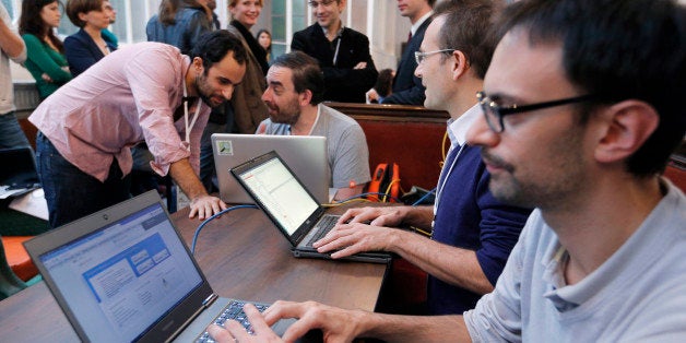 Software developers work on laptops during the 'Hackathon Dataculture', a one-or two-day hack event dedicated to open cultural data on October 25, 2013 in Paris. The hackathons are informal workshops bringing together software developers during one or two days, to build projects and prototypes and develop innovative applications for open cultural data. AFP PHOTO / FRANCOIS GUILLOT (Photo credit should read FRANCOIS GUILLOT/AFP/Getty Images)