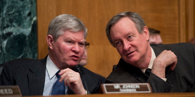 UNITED STATES - FEBRUARY 27: Chairman Tim Johnson, D-S.D., left, and Sen. Mike Crapo, R-Idaho, ranking member, conduct Senate