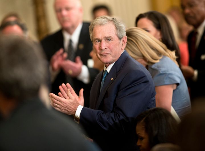 Former President George W. Bush claps during a portrait unveiling ceremony in the East Room of the White House May 31, 2012 in Washington, DC. US President Barack Obama and First Lady Michelle Obama hosted George Bush, the 43rd President of the United States, and his wife Laura Bush to unveil their official White House portrait. AFP PHOTO/Brendan SMIALOWSKI (Photo credit should read BRENDAN SMIALOWSKI/AFP/GettyImages)