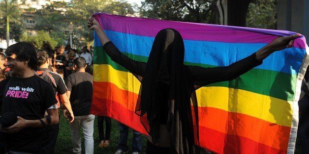 An Indian activist holds a gay pride flag during a rally to protest against the Supreme Court ruling reinstating a ban on gay sex in Mumbai on December 15, 2013. India's government said December 12 it would look at ways to swiftly reverse a shock ruling December 11, 2013 which reinstated a ban on gay sex, accusing the Supreme Court of dragging the country back to the 19th century. AFP PHOTO/ PUNIT PARANJPE (Photo credit should read PUNIT PARANJPE/AFP/Getty Images)