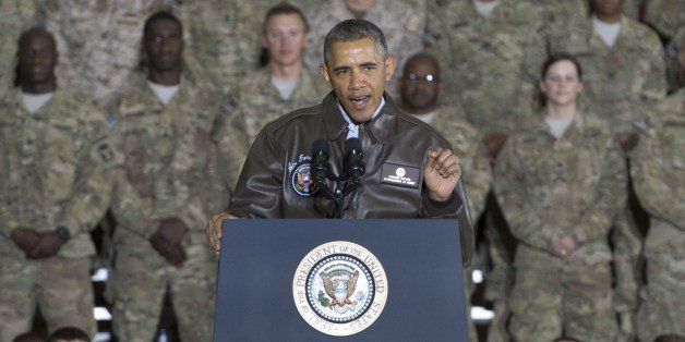 US President Barack Obama addresses US troops during a surprise visit to Bagram Air Field, north of Kabul, in Afghanistan, May 25, 2014, prior to the Memorial Day holiday. AFP PHOTO / Saul LOEB (Photo credit should read SAUL LOEB/AFP/Getty Images)