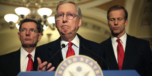 WASHINGTON, DC - MARCH 05: U.S. Senate Minority Leader Sen. Mitch McConnell (R-KY) (2nd L) speaks as Sen. John Barrasso (R-WY) (L) and Sen. John Thune (R-SD) (R) listen during a news briefing March 5, 2014 on Capitol Hill in Washington, DC. Senate GOP leaders spoke to members of the media after their weekly policy luncheon. (Photo by Alex Wong/Getty Images)