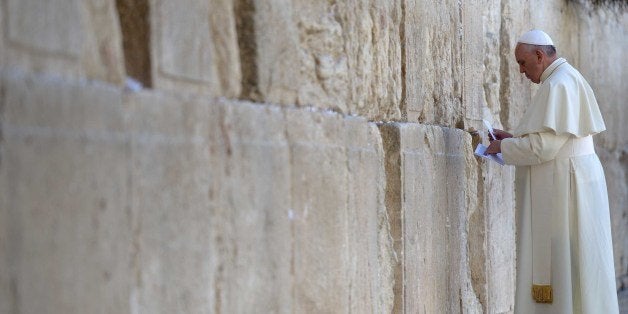 JERUSALEM - MAY 26: Pope Francis places a prayer paper at the Western Wall, Judaism's holiest site, in the Old City of Jerusalem on May 26, 2014. The Vatican's Pope Francis on Monday prayed at the Western Wall, which Jews regard as a sacred site located at the foot of the western side of the Al-Aqsa Mosque compound in Al-Quds (occupied East Jerusalem). (Photo by Avi Ohayon/Israeli GPO/Pool/Anadolu Agency/Getty Images)