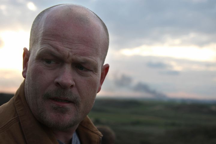 Samuel Joseph Wurzelbacher, or 'Joe the Plumber,' the Ohio man who shot to fame last year after he challenged then presidential candidate Barack Obama over his tax proposals, stands near the Israeli border with the Gaza Strip as smoke from Israeli artillery shells covers the Hamas run territory on January 11, 2009. �Joe the Plumber�, is morphing into 'Joe the War Correspondent'. He traveled to Israel to report for US conservative website pjtv.com, giving the perspective of ordinary Israelis on the conflict in Gaza. AFP PHOTO/PATRICK BAZ (Photo credit should read PATRICK BAZ/AFP/Getty Images)