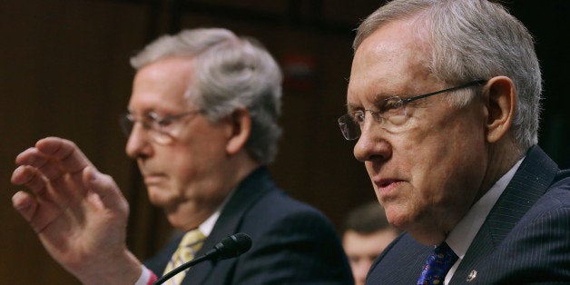 WASHINGTON, DC - JUNE 03: (EDITORS NOTE; THIS IMAGE WAS CREATED USING A VARIABLE FOCAL PLANE LENS) Senate Majority Leader Harry Reid (D-NV) (R) and Senate Minority Leader Mitch McConnell (R-KY) testify before the Senate Judiciary Committee about political donations and freedom of speech in the Hart Senate Office Building June 3, 2014 in Washington, DC. Liberal political groups delivered boxes filled with two million petitions calling for a campaign finance constitutional amendment and pushing for '...a proposed constitutional amendment to restore the ability of Congress and the states to regulate the raising and spending of money in elections.' (Photo by Chip Somodevilla/Getty Images)