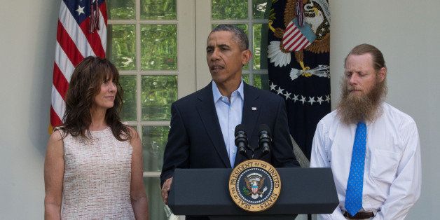 WASHINGTON, DC - MAY 31: President Barack Obama makes a statement about the release of Sgt. Bowe Bergdahl as his parents, Jani Bergdahl (L) and Bob Bergdahl (R) listen May 31, 2014 in the Rose Garden at the White House in Washington, DC. Sgt. Bowe Bergdahl was held captive by militants for almost five years during the war in Afghanistan. (Photo by J.H. Owen-Pool/Getty Images)