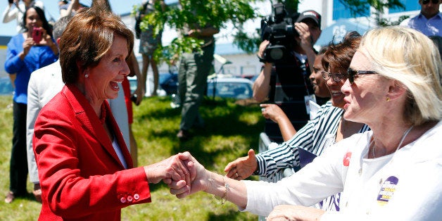 HYDE PARK, MA - JUNE 2: Leader Nancy Pelosi shakes hands with members of the crowd at a When Women Succeed, America Succeeds rally in Hyde Park, Mass. on June 2, 2014. (Photo by Jessica Rinaldi/The Boston Globe via Getty Images)